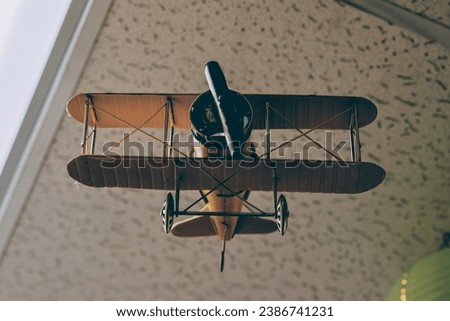 An old airplane model hanging on a ceiling