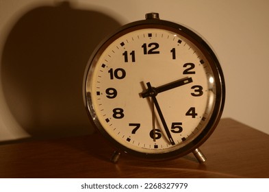 an old alarm clock on the table