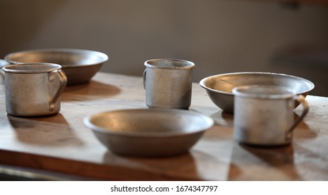 The old aluminum utensils on the table in the prison ward