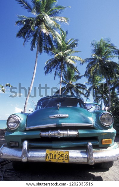 a old\
american car on a beach at the coast of Varadero on Cuba in the\
caribbean sea.    Cuba, Varadero, September,\
2005
