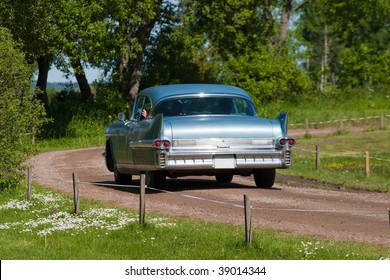 Old American Classic Car On A Gravel Road