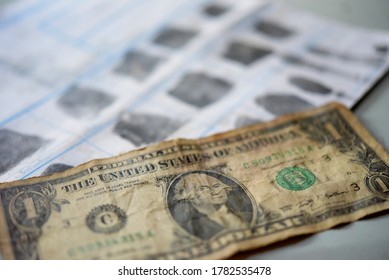 Old American Dollar Banknote On Fingerprint Crime Page File.Economic Crime Concept.