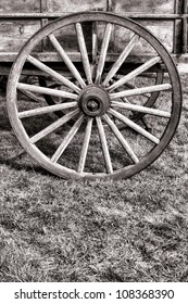 Old American Pioneer Prairie Schooner Wagon Antique Wood Spoke Wheel Over Prairie Grass