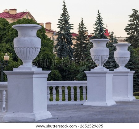 Old, ancient type columns in shape of vases placed outdoors