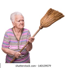 Old angry woman threatening with a broom on a white background