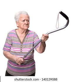 Old angry woman threatening with a cane on a white background