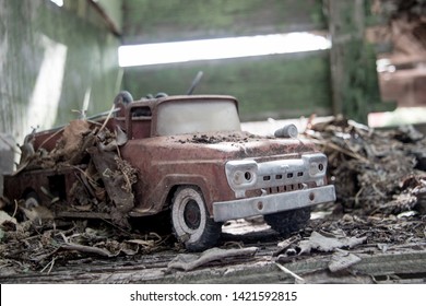 Old Antique 1960s Toy Fire Truck Covered In Leaves And Dirt.