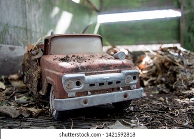 Old Antique 1960s Toy Fire Truck Covered In Leaves And Dirt.