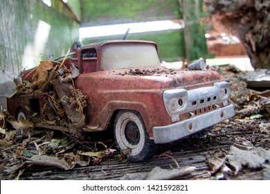 Old Antique 1960s Toy Fire Truck Covered In Leaves And Dirt.