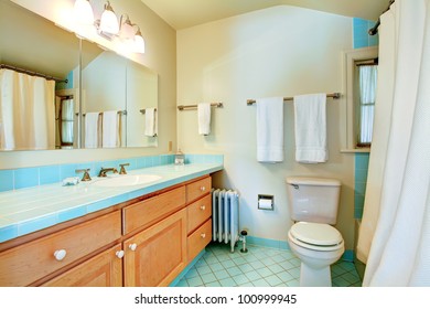 Old Antique Bathroom With Blue Tiles And White Shower.