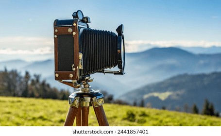 old antique bellows film camera on wooden tripod taking picture of landscape, outdoors photography, close up side rear view of camera - Powered by Shutterstock