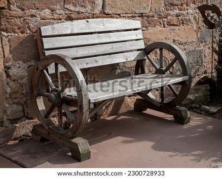 old antique bench on the wooden wheels