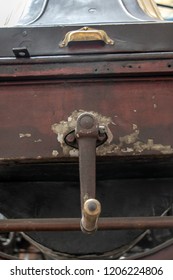 An Old Antique Car With A Hand Crank For Start, Close Up. The Starter Handle On The Renault AX Car, Year 1909.