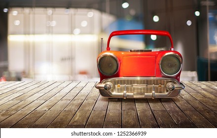 Old Antique Car Shape AM FM Stereo Cassette Player On Wood Table Top With Blur Background