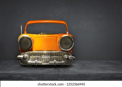 Old Antique Car Shape AM FM Stereo Cassette Player On Cement  Background