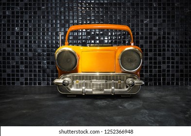 Old Antique Car Shape AM FM Stereo Cassette Player On Mosaic Tiles Background