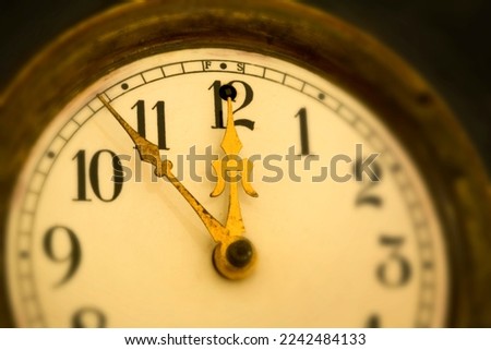 An old antique clock set at the eleventh hour.