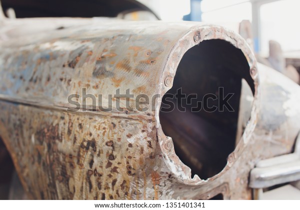 Old antique
rusty car in outback headlight,
body.