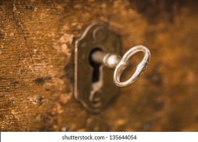 Old Antique Skeleton Key In Lock Of Wooden Cabinet