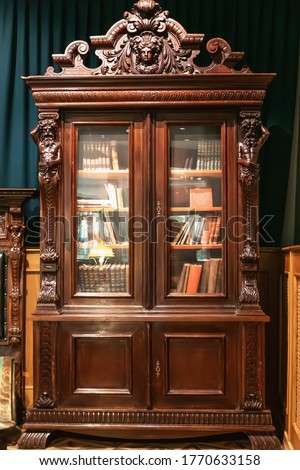 Old antique vintage wooden bookcase with books.