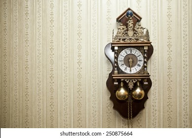 old antique wood clock with carvings for metal hanging on the wall 