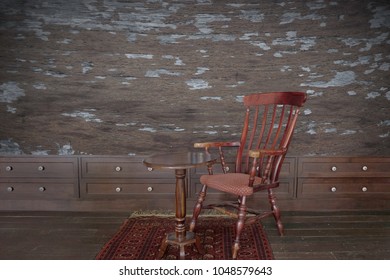 Old antique wooden chair and table in the room. Have a wood wall.