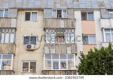 Old apartment block from communist era in Eastern Europe. Communist socialist architecture style flat. Dreary and depressive rust-eaten building.