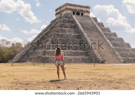 Old architecture built by Maya people of the Terminal Classic period. Young woman is spending vacation in old city.Temple of Kukulcan, UNESCO World Heritage Sites.Chicken Itza, Mexico 25 March 2025