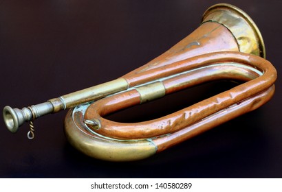 Old Army Bugle Isolated On A Black Background.