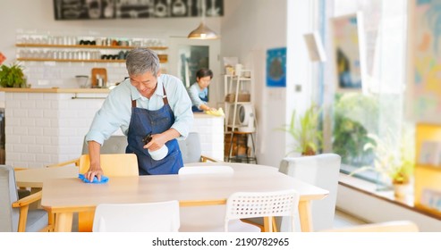 old asian couple cleaning the coffee shop - Powered by Shutterstock