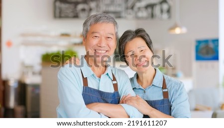 old asian couple smilimg happily in the coffee shop