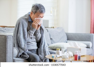 Old Asian Man Get A Cold And Sneeze With Tissue Paper At Home