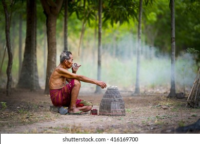 Old Asian Man Sitting Outside And Drinking Whiskey