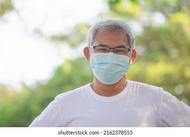 Old Asian Man Walking Exercise Outdoor And Wearing Medical Mask  