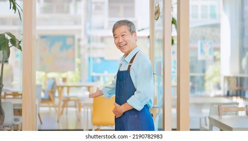 Old Asian Man Wecomimg Customers At Front Door In Cafe Or Restaurant