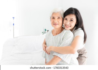 old asian patient sick and admit in hospital, young asian female visiting old female, she hug old female, they feeling happy and smile in mother's day, elderly healthcare