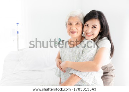 old asian patient sick and admit in hospital, young asian female visiting old female, she hug old female, they feeling happy and smile in mother's day, elderly healthcare
