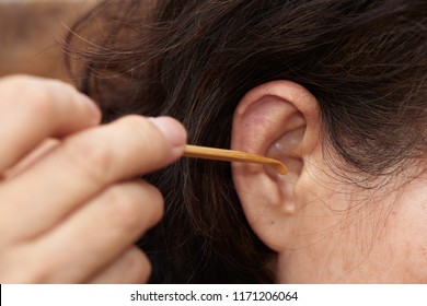 A Old Asian Woman Cleaning Ear Using Wooden Earpick For Removing Wax