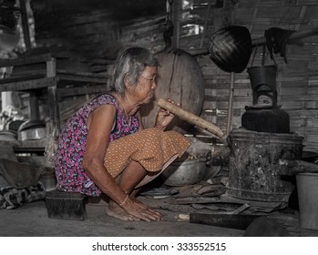 Old Asian Woman With Dryer Fire Stove For Boiling A Kettle,Nong Khai,Thailand