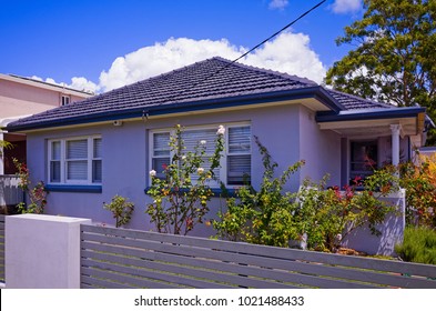 Old Australian Suburban Residential House. Building Exterior With Garden, Lawn And Fence In The Suburb Of Thirroul, Wollongong, New South Wales. Private Home In Australia.