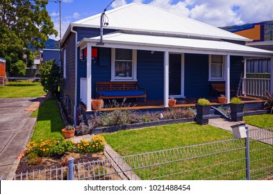 Old Australian Suburban Residential House. Building Exterior With Garden, Lawn And Fence In The Suburb Of Thirroul, Wollongong, New South Wales. Private Home In Australia.