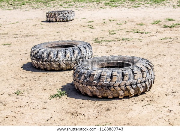 Old auto tires in the\
mud