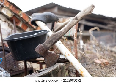 an old axe stuck in a stump