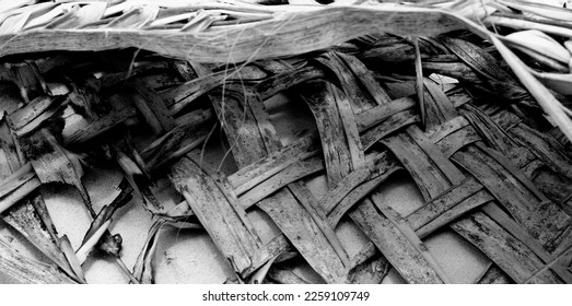 Old bag of woven palm frond washed-up on tropical beach in South Pacific. - Shutterstock ID 2259109749