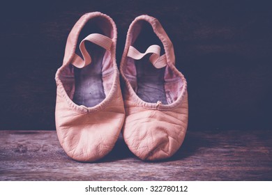 Old Ballet Shoes On Old Wooden Floor.