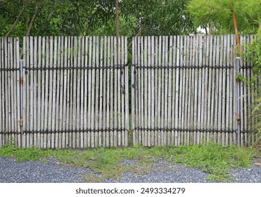 Old bamboo fence gate in the garden. - Powered by Shutterstock