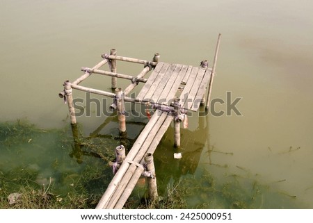 Old bamboo and wood made fishing platform. fishing lake of Bangladesh.