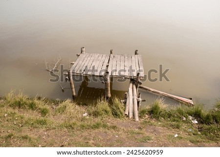 Old bamboo and wood made fishing platform. fishing pond of Bangladesh.