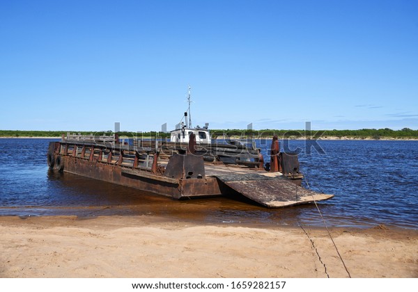Old barge for crossing cars and people between\
the islands