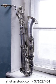 Old Baritone Saxophone In The Window Of An Abandoned House